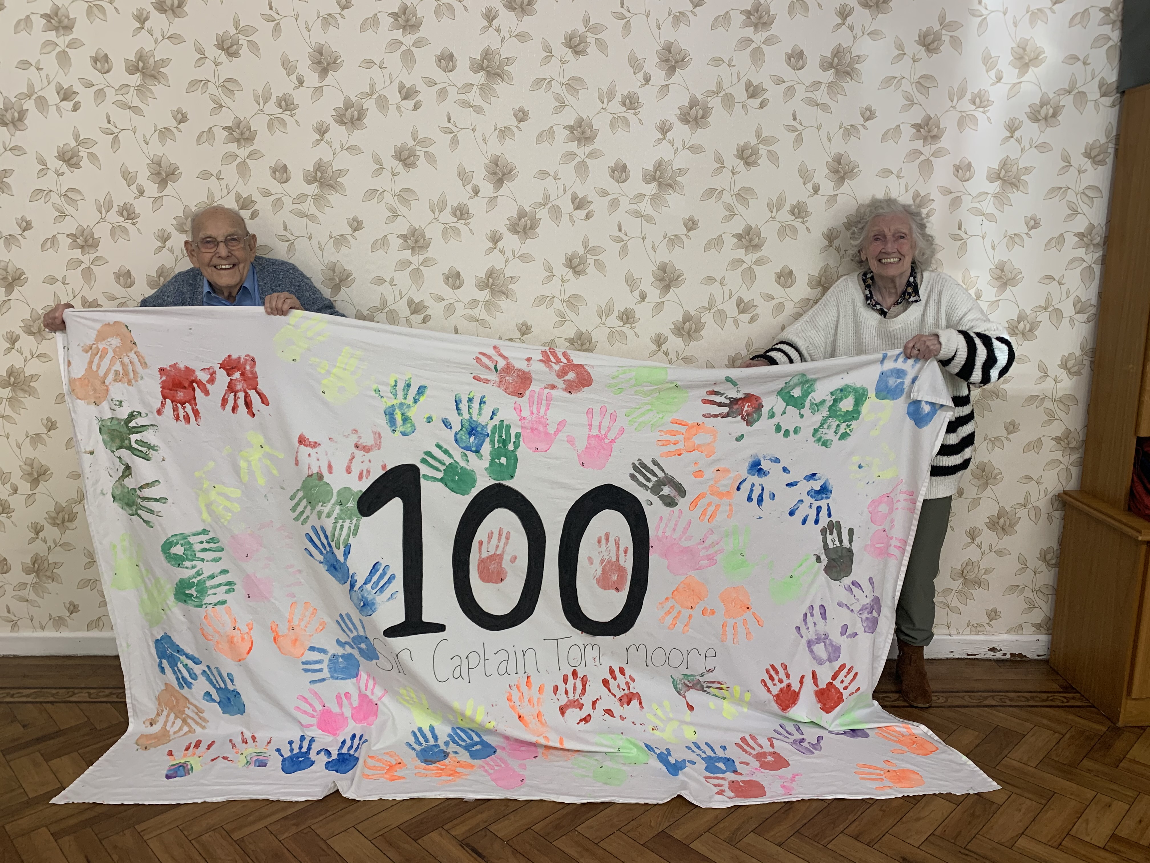 Residents of Downing House placed 100 handprints on a sheet to mark and remember the occasion Image