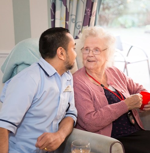 Mandeep chatting to female resident