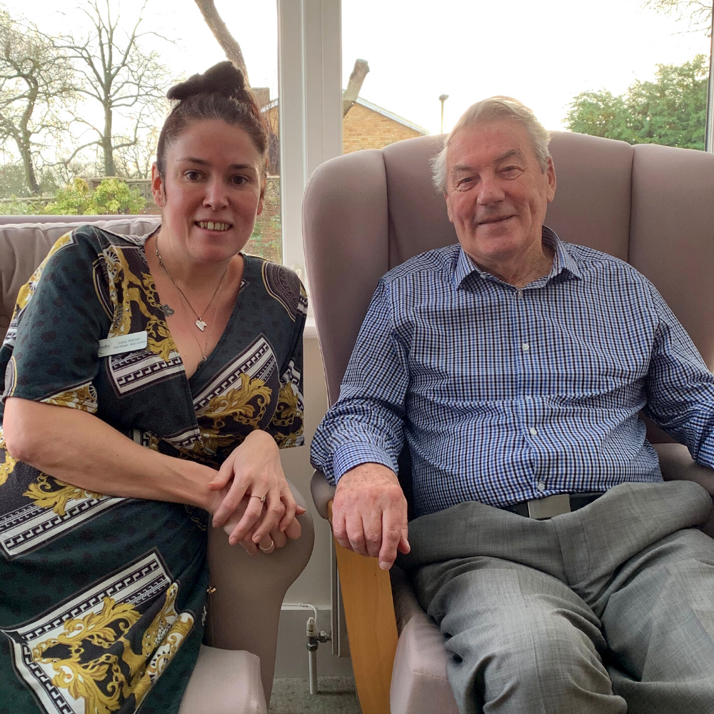 John, resident at Sibleys Orchard sitting with House Manager, Lena