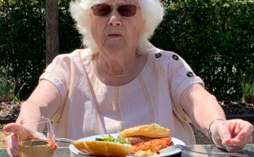 Helen form Girton Green enjoying some food from the BBQ Image